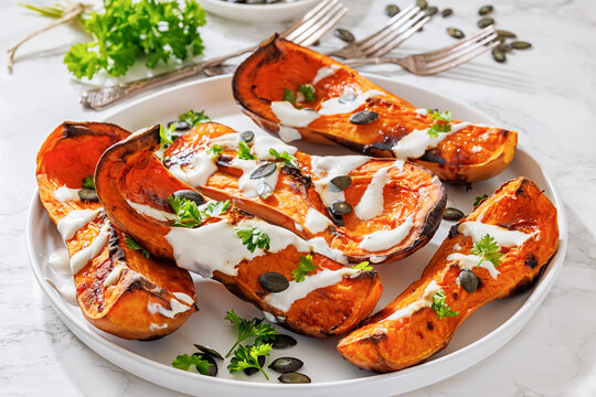 Baked butternut squash halves with yogurt sauce