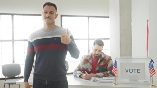 Man giving thumbs up beside a clear ballot box and registration table inside a polling building; civic pride.