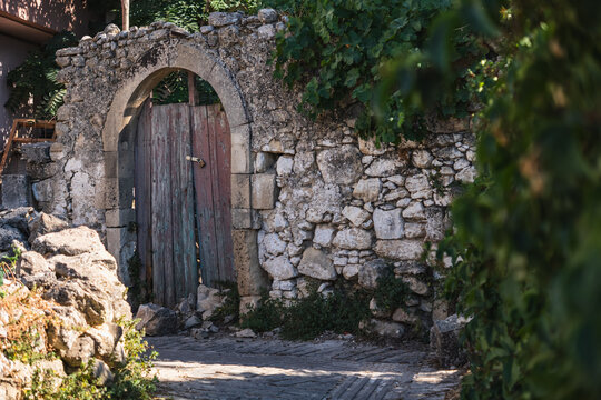 a narrow street in the small Greek town of Margarites on the island of Crete
