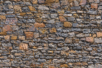 Fototapeta premium close-up of a wall built of numerous stones