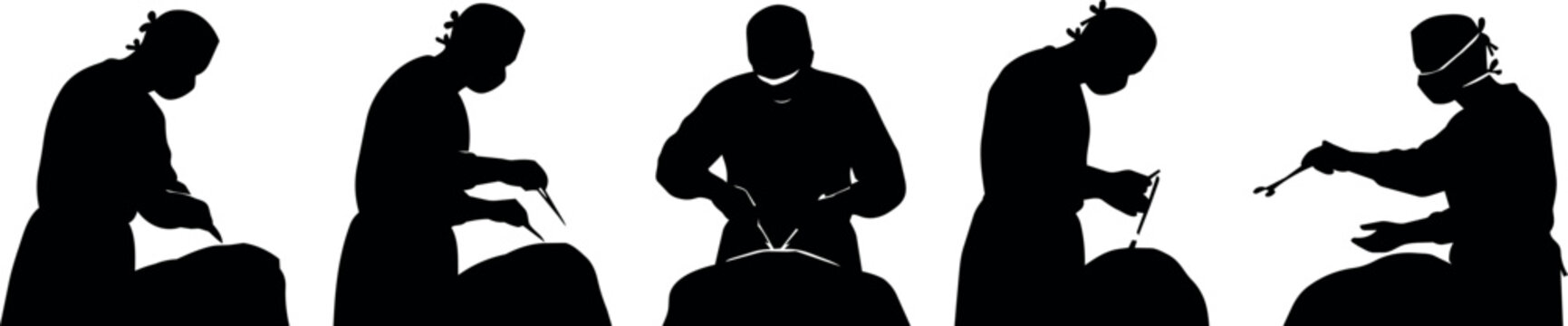 Silhouettes of surgeons performing a medical operation in a sterile environment