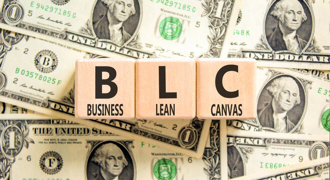 BLC business lean canvas symbol. Concept words BLC business lean canvas on beautiful wooden blocks. Beautiful dollar bills background. BLC business lean canvas concept. Copy space.