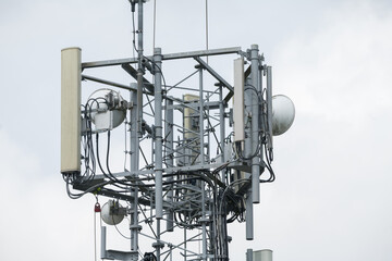 Fototapeta premium Corby, United Kingdom – July 25, 2026: Cellular communication tower with antennas and wireless network equipment, editorial
