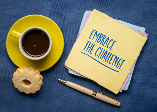 Embrace the Challenge. Inspirational handwritten note with coffee and pen, encouraging courage, resilience, growth, and stepping outside your comfort zone.