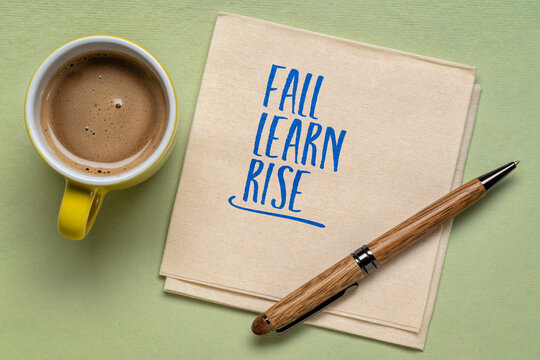Fall. Learn. Rise. Inspirational handwritten note on a napkin with coffee and pen, symbolizing resilience, perseverance, personal growth, and success.