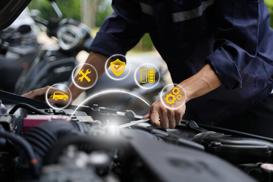 Automotive mechanics test customer service concepts using automotive diagnostic tools and artificial intelligence (AI) on laptops to verify quality.