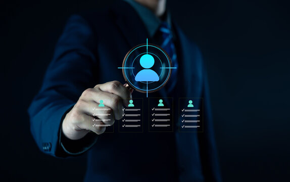Businessman holding digital human resource icon with employee profiles, symbolizing recruitment, HR management, staff selection, corporate workforce strategy, and human capital development in modern.