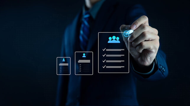 Businessman holding digital human resource icon with employee profiles, symbolizing recruitment, HR management, staff selection, corporate workforce strategy, and human capital development in modern.