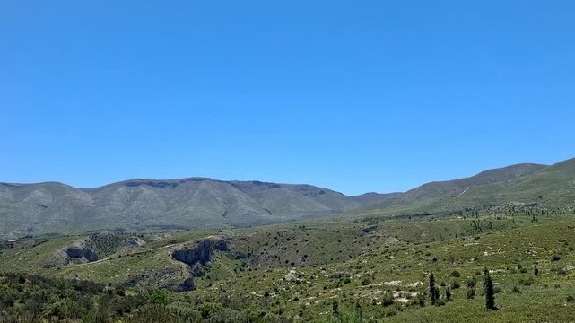 Cinematic slow motion view of Serra de la Carrasca mountains in Vall de Ebo Spain from a moving car