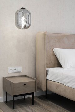 Bedside table with hanging lamp
