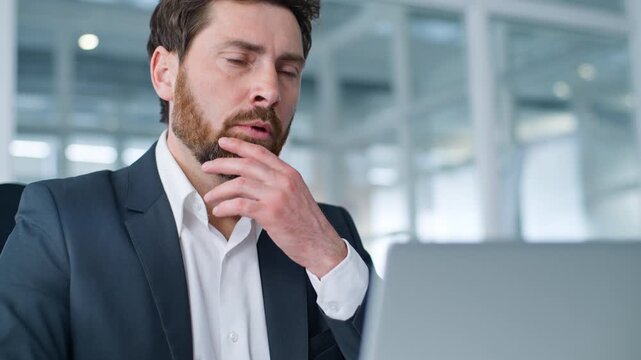 Closeup focused concern Caucasian middle-aged business man working thinking with laptop cyberspace chatting with client problem solving think businessman work with computer male entrepreneur in office