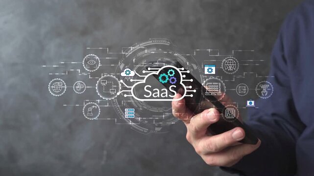 Hand holding a smartphone with SaaS cloud interface and automation icons, illustrating digital business platforms, cloud computing, and software service technology.