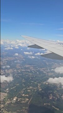 Passenger view from airplane window during flight, perfect b-roll for travel, vacation and aviation industry.