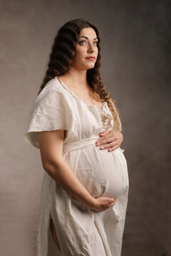 Artistic Maternity Portrait of Pregnant Woman in Medieval Gown