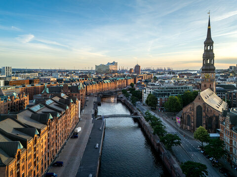 Aerial view of the historic Speicherstadt district with its iconic red-brick warehouses, canals, and the St. Catherine's Church in Hamburg, Hamburg, Germany.
