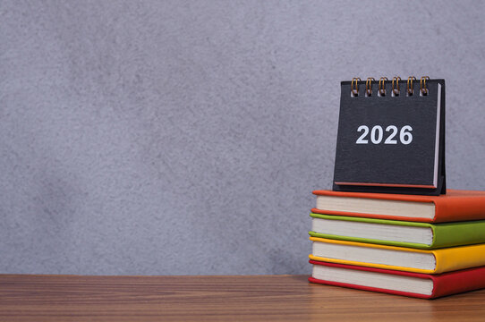 Student creative desktop, 2026 desk calendar on hardcover book. Copy space for text, Back to school, Education concept