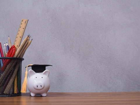 Student creative desktop, Colorful stationery and piggy bank with graduation hat. Copy space for text, Back to school, Education concept
