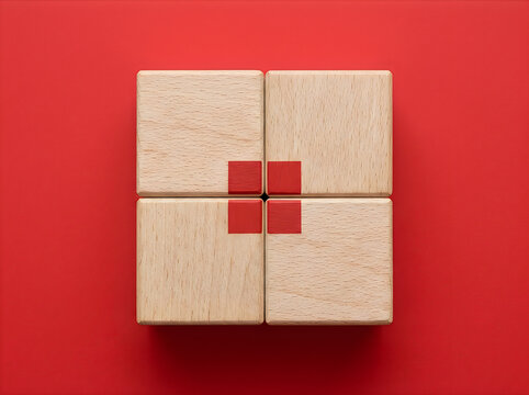Four light wooden puzzle blocks with small red cubes on red background