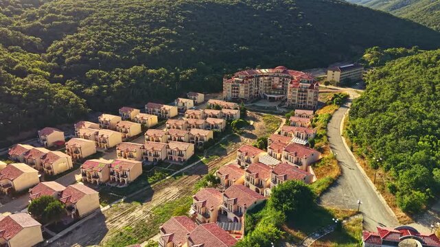 Buildings in Elenite show the effects of recent flooding. Roads and homes are affected, and nature surrounds the area. The aftermath highlights the impact of weather events on the city.