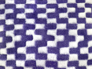 Close up of fabric textile in checkered rectangular pattern in purple and white color. Seamless background texture. © TMR Studio