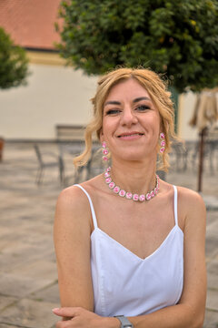 ​Portrait of confident smiling mature woman looking at camera, elegant summer style