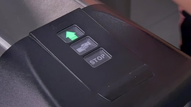 A traveler approaches a turnstile at a bustling transit station, ready to embark on an adventure. With a quick card swipe, the journey begins as the light turns green, welcoming the wanderer onward.