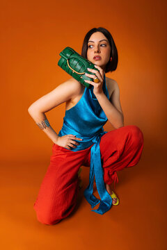 Woman posing with green statement clutch 