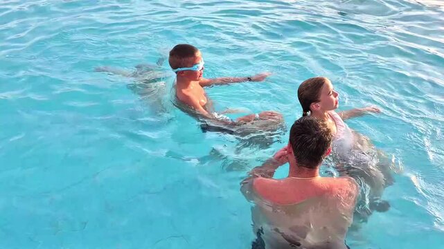The family is having fun in the pool.