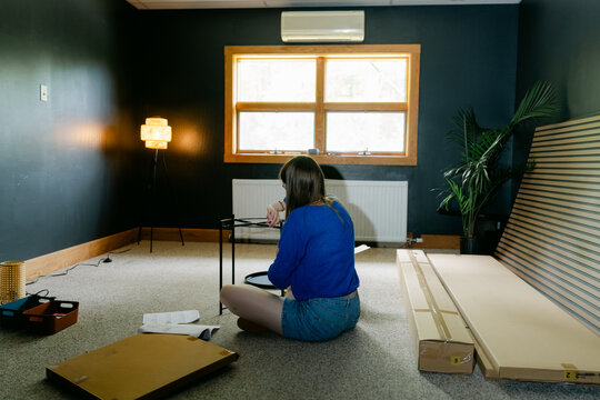 anonymous woman assembling furniture 