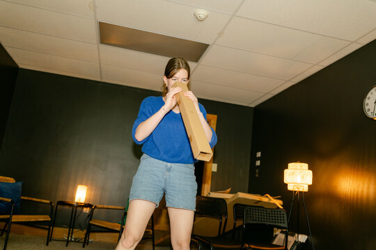 young woman assembling furniture in conference room 