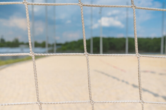 Beach volleyball net closeup on sandy beach background