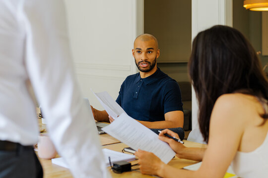Business professionals discussing documents during a meeting