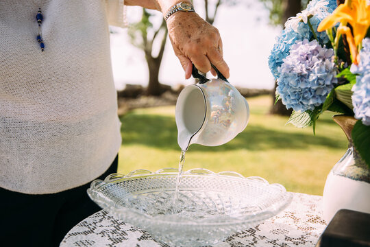Woman pouring water for baptism 
