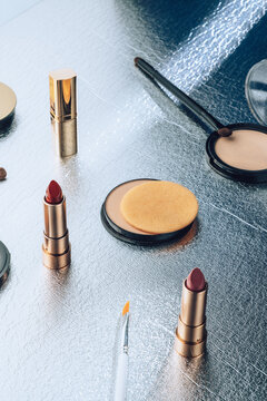 Various scattered make up items .