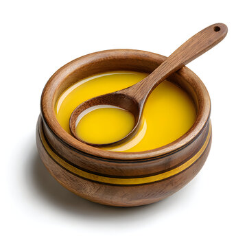 Ghee or clarified butter in a rustic wooden bowl with a spoon, clarified