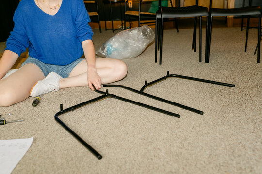 anonymous woman assembling furniture 