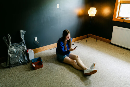 young woman looking at her phone in conference room