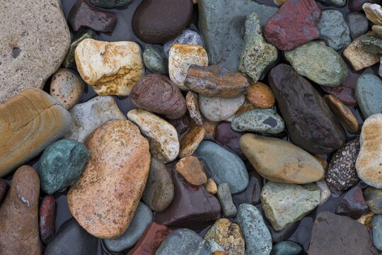 Coloured rhyolite rock by a stream, L&oacute;ns&ouml;r&aelig;fi, south-east Iceland