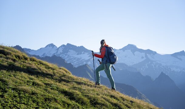 Hiker enjoying the mountain panorama in the morning, Venediger group, behind Dreiherrenkopf, Simonysitze and Gro&szlig;er Geiger, Hohen Tauern, Austria
