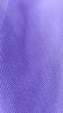 Soft violet net fabric moving gently, Vertical video orientation, perfect for social media backgrounds, fashion design, or textile material demonstrations.