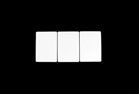 Three blank white rectangular playing cards arranged side by side with rectangles gambling template