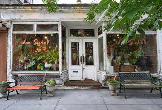 Quaint old store in the Brooklyn Heights area of New York City, with benches and profuse plants