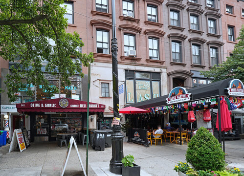 New York City, brownstone apartment building with stores and restaurants on the ground floor