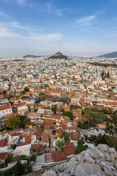 Scenic view of the Lycabettus hill and downtown of Athens in Greece on a sunny day. Urban skyline, metropolis and city view from above.