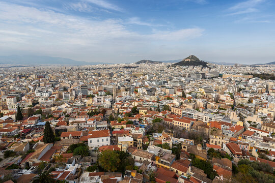 Scenic view of the Lycabettus hill and downtown of Athens in Greece on a sunny day. Urban skyline, metropolis and city view from above.