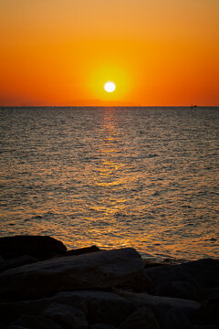 A beautiful sunset over the Aegean Sea on the island of Paros in Greece.