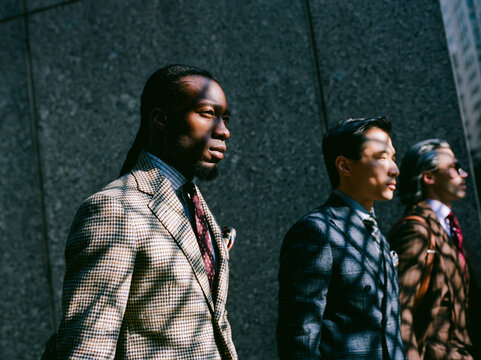 Diverse Business Professionals Standing Together Against Wall