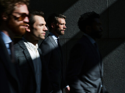 Business Professionals Standing Against Dark Wall