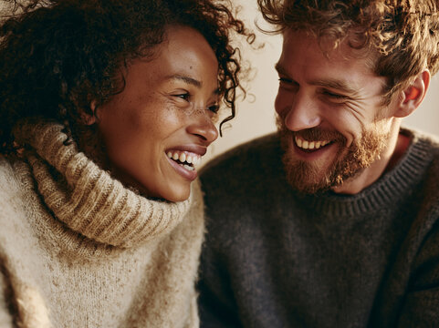 Couple Laughing Together in Warm Sweaters