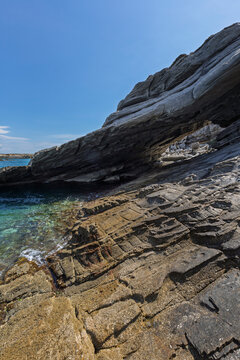 Stunning and big natural arc by the sea at the Paros Park on Paros island in Greece on a sunny day. Rocky geological landscape and natural attraction.